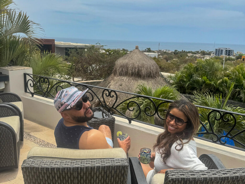 photo of a couple enjoying drinks and the view in Cabo