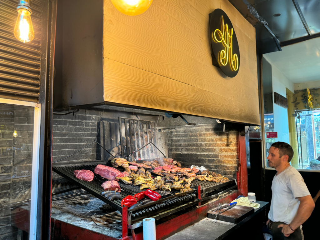 photo of a man cooking at the Mercado del Puerto in Uruguay