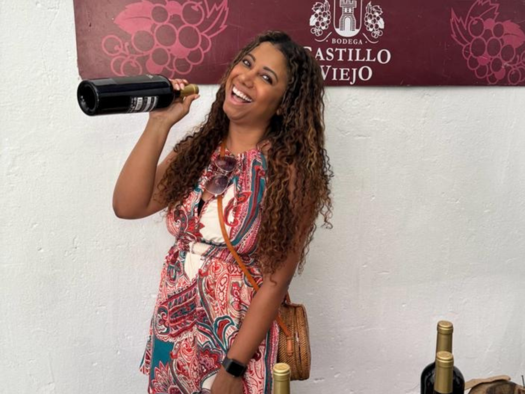 Photo of Elicit Folio holding wine bottle at Castillo Viejo in Uruguay