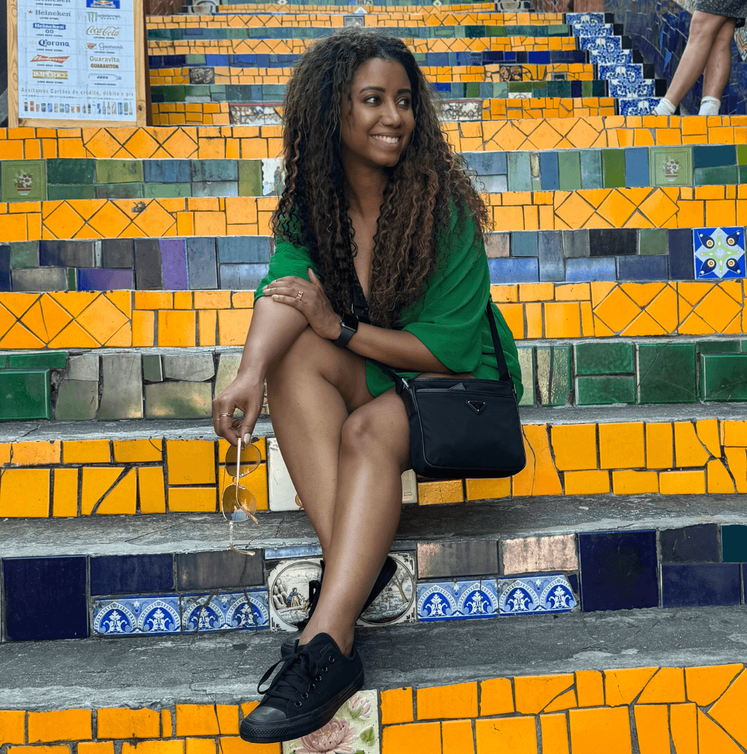 Photo of Ebony creator of Leisure Folio sitting on the famous Escadaria Selarón (Selarón Steps) in Rio de Janeiro